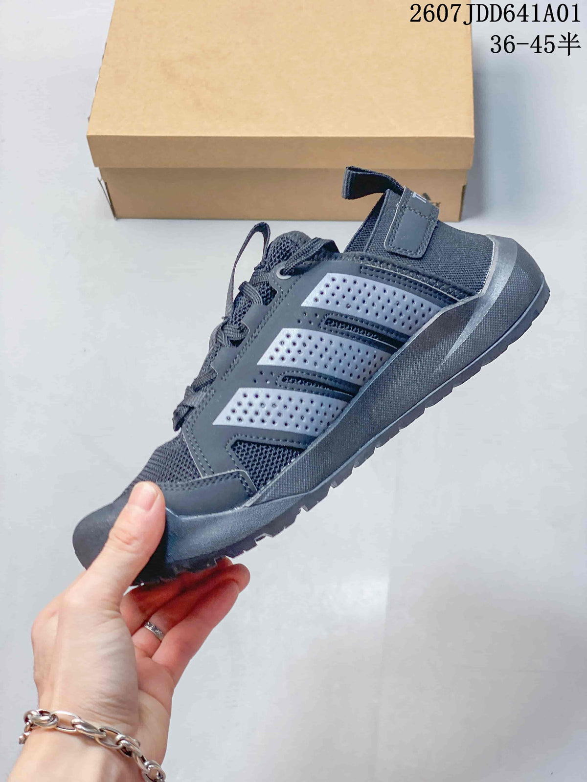 Side view of a gray outdoor sneaker with perforated panels and a rugged sole.