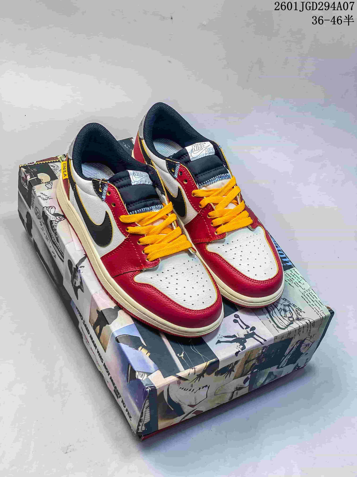 Pair of red, white, black, and yellow low-top sneakers displayed on a graphic shoebox.