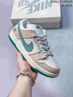 Angled side view highlighting the white upper, woven-texture overlays, green branding detail, and orange and green outsole accents.