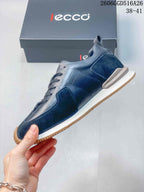Side view of the navy sneaker with mixed-texture panels and light-colored midsole