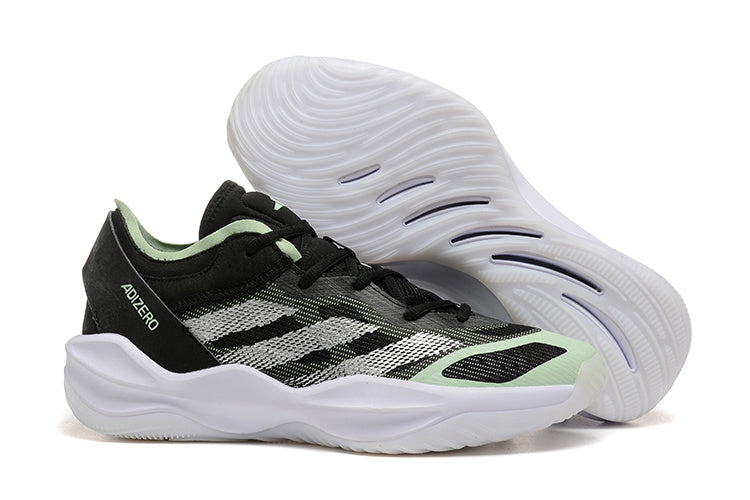 Black Adidas Adizero shoe beside its white patterned outsole