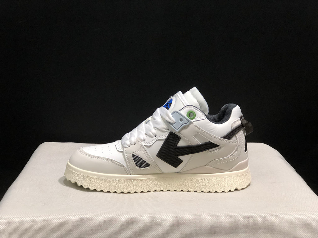 Side profile of one white sneaker with a large black arrow-shaped side detail.