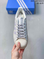 Top view showing the laces, tongue label, perforated upper, and textured shell toe.