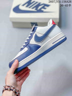 Side view showing the white and blue upper, layered Swoosh detail and blue outsole.