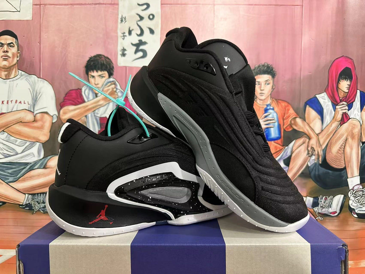 Two black Jordan basketball shoes displayed at an angle, showing the side panels and outsoles