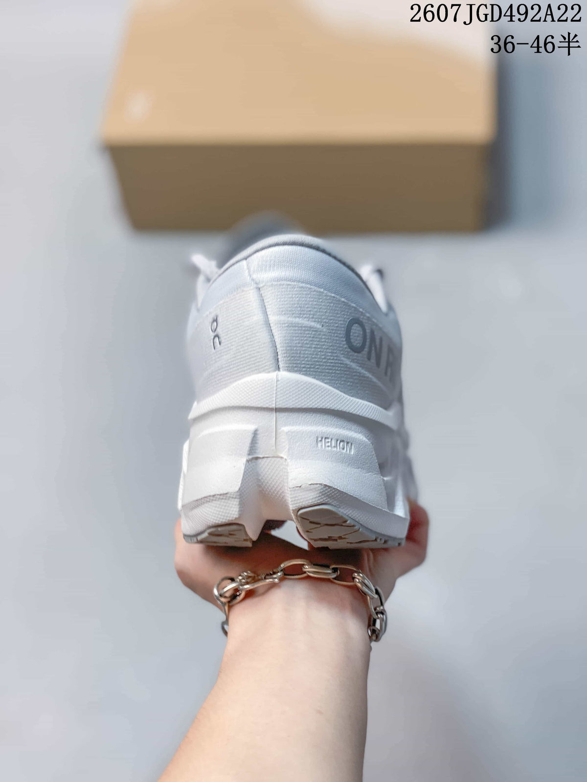 Rear view of the shoe showing the padded heel collar, On branding and segmented outsole.