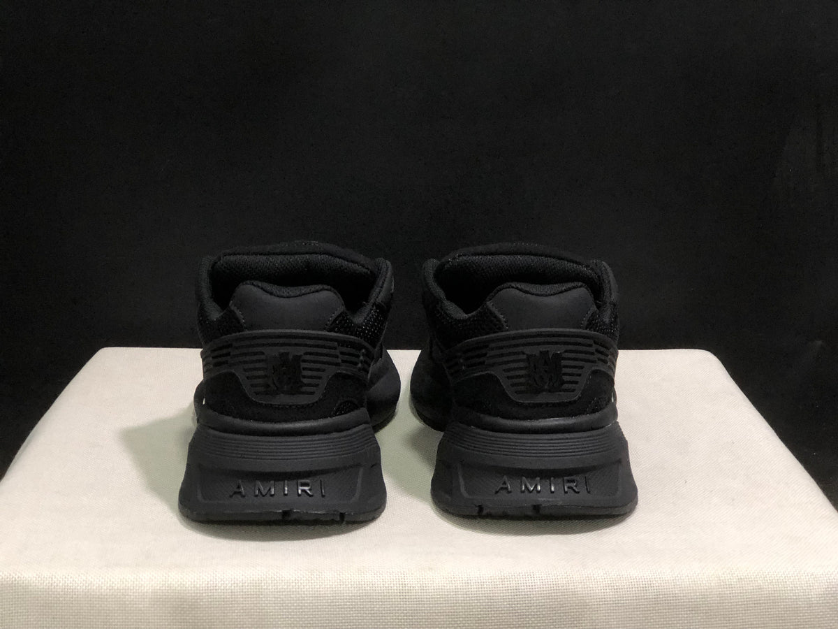 Rear view showing AMIRI branding on the heel counters and outsole sections.