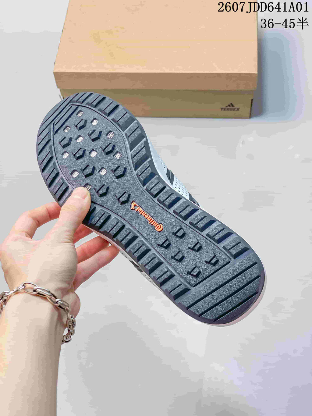Close-up of the patterned outsole on a dark gray sneaker