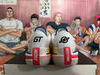 Rear view of white Nike GT basketball shoes with blue trim and red heel details.