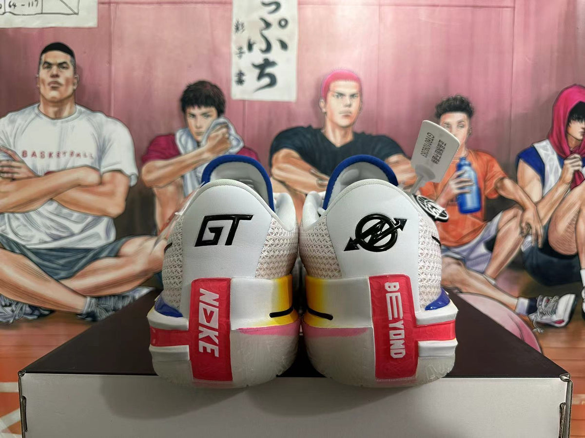 Rear view of white Nike GT basketball shoes with blue trim and red heel details.