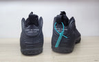 Rear view of black high-top sneakers with Comme des Garçons Homme Plus heel branding.