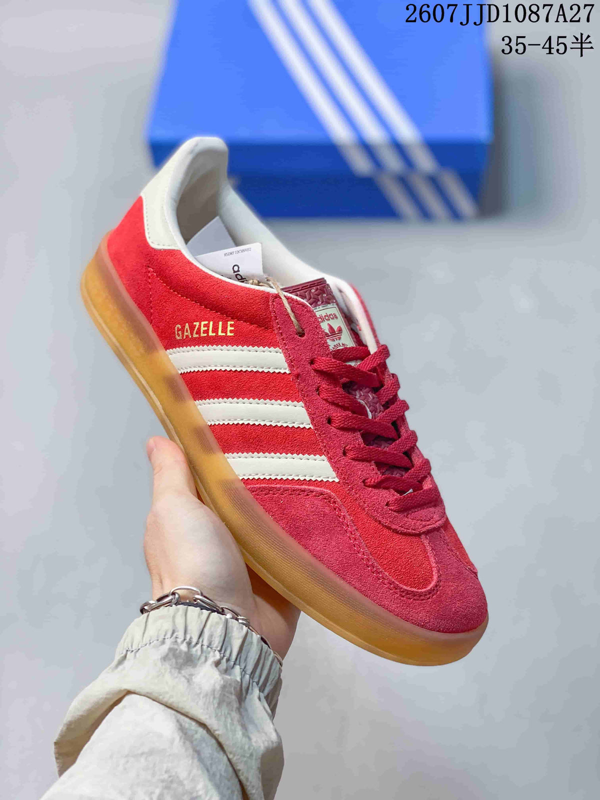 Angled side view of the red sneaker with white stripes and visible GA ZELLE side marking.