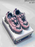 Pink and charcoal FILA Fusion chunky sneakers shown from the front on a shoebox.