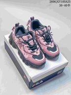 Pink and charcoal FILA Fusion chunky sneakers shown from the front on a shoebox.