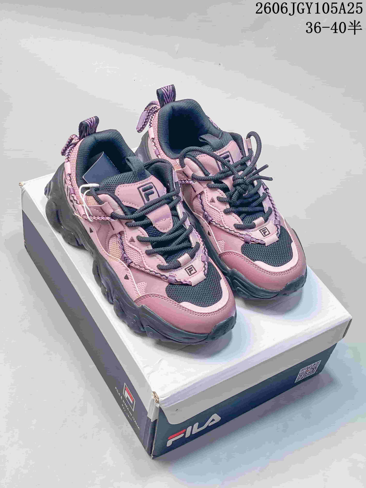 Pink and charcoal FILA Fusion chunky sneakers shown from the front on a shoebox.