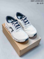 Pair of white and navy On Cloudmonster 3 LightSpray running shoes on a box