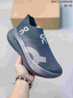 Angled side view of the dark gray slip-on sneaker with contrasting side detail.