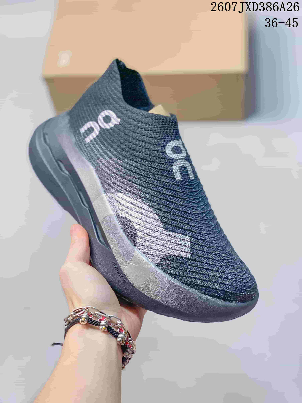 Angled side view of the dark gray slip-on sneaker with contrasting side detail.