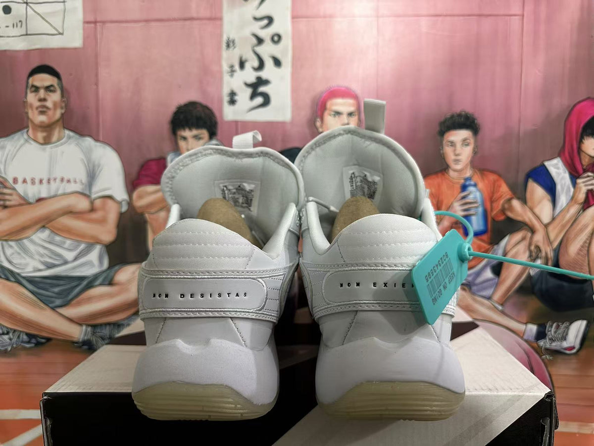 Rear view of white Jordan basketball sneakers showing padded collars, heel branding and translucent outsoles.