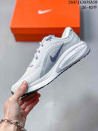 Side profile of the Nike Journey Run sneaker showing the mesh-like upper, lavender Swoosh and cushioned midsole.