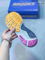 Close view of the sneaker outsole showing yellow, gray, and pink patterned tread sections.