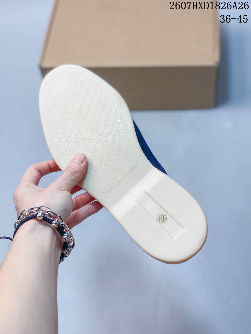 Underside view of the cream-colored sole showing a repeating textured tread and molded branding details.