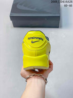 Rear view of the yellow Nike Air Max 90 sneaker showing Total Air branding and a Nike logo.