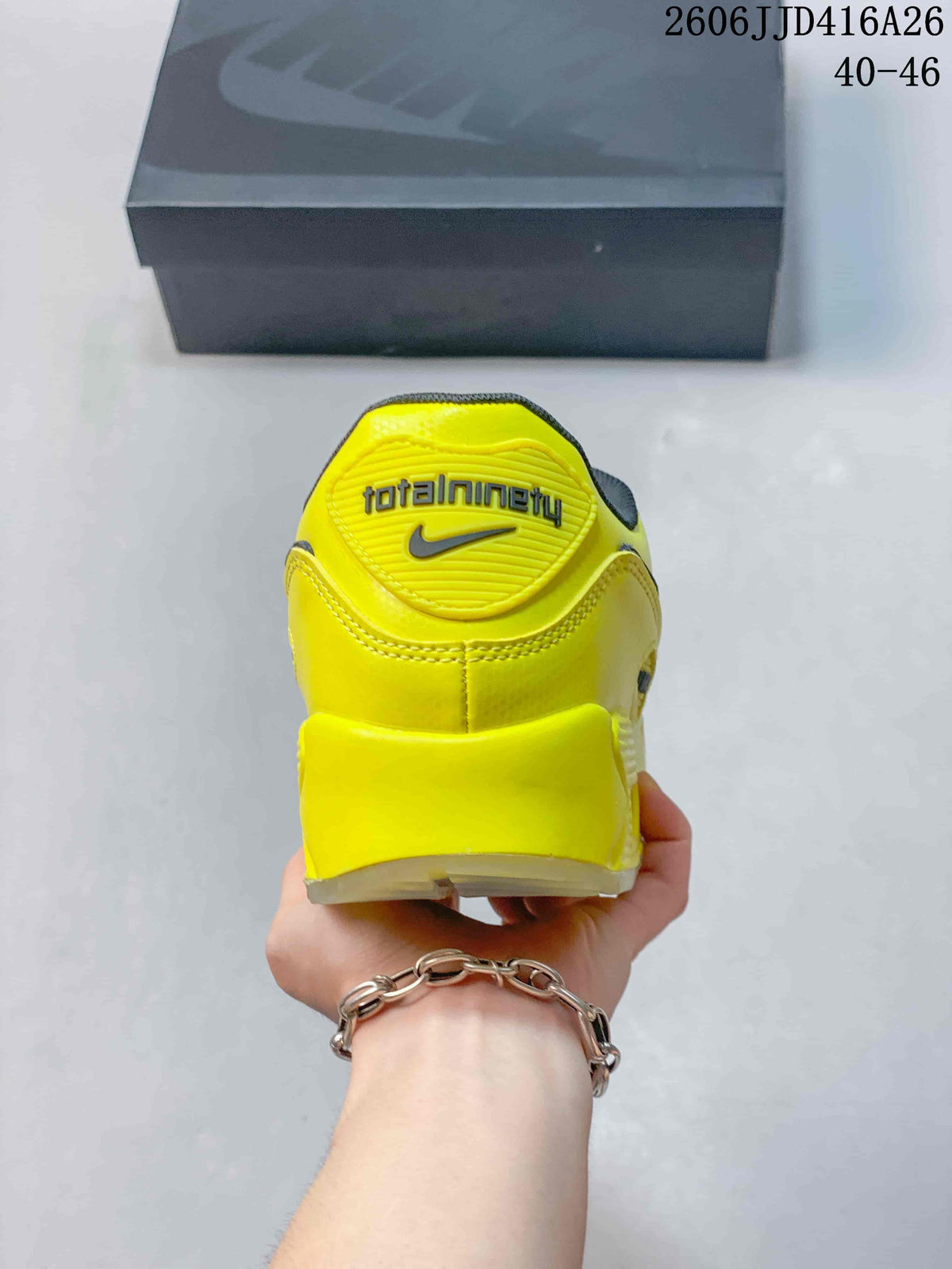 Rear view of the yellow Nike Air Max 90 sneaker showing Total Air branding and a Nike logo.