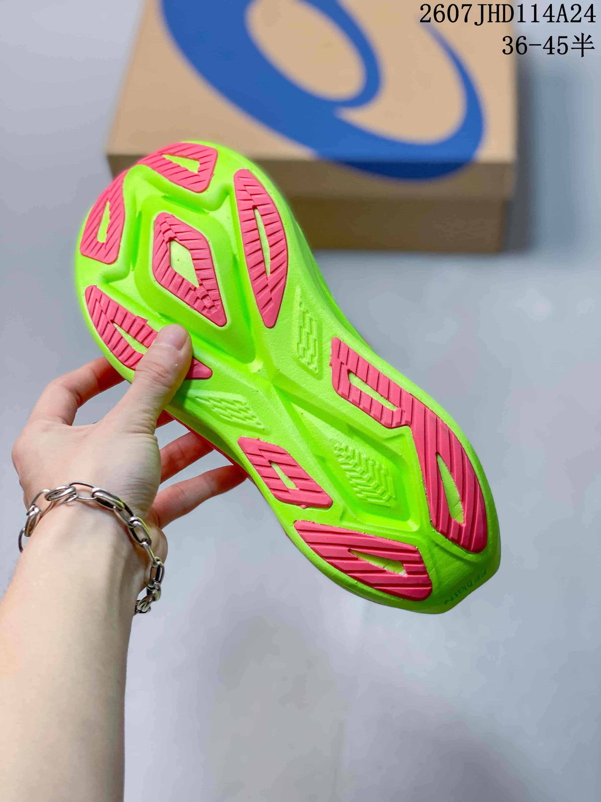 Close view of the lime green outsole with pink traction sections on an ASICS running sneaker.