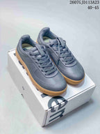 Pair of dark gray lululemon Cityverse sneakers with matching laces and gum-colored outsoles displayed on a shoebox; image text shows style code 2607GJD113A23 and size range 40–45.