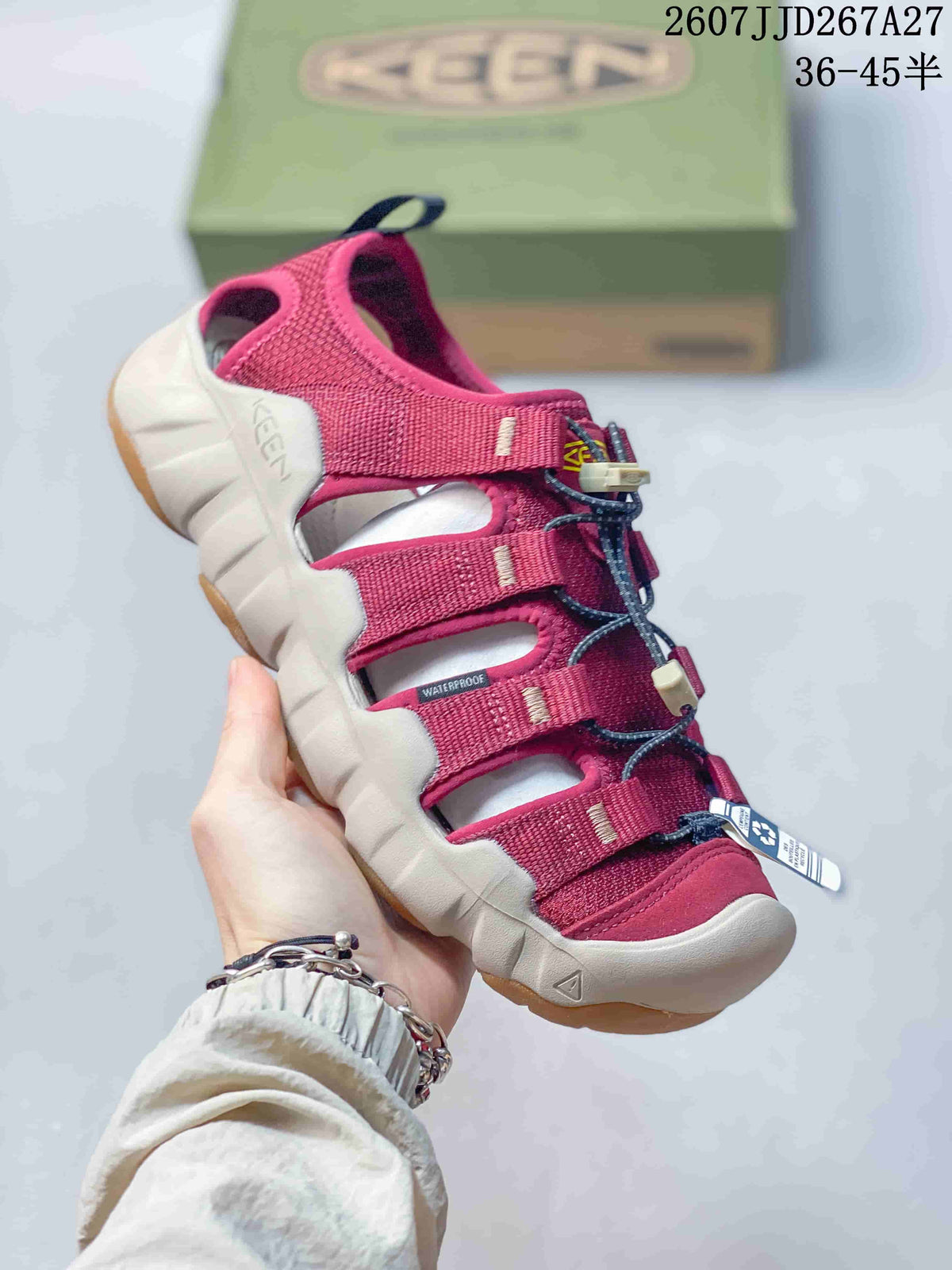Angled side view of a burgundy KEEN sandal showing the open upper, adjustable straps, rear pull tab, and light-colored sole.