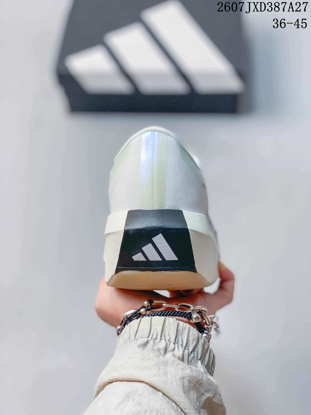 Rear view of the white sneaker showing the adidas logo on a dark heel panel.