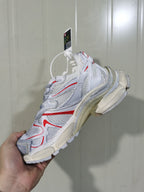Side view of the Puma 9260 Runner 2 sneaker highlighting its layered upper, red detailing, and sculpted runner-style sole.