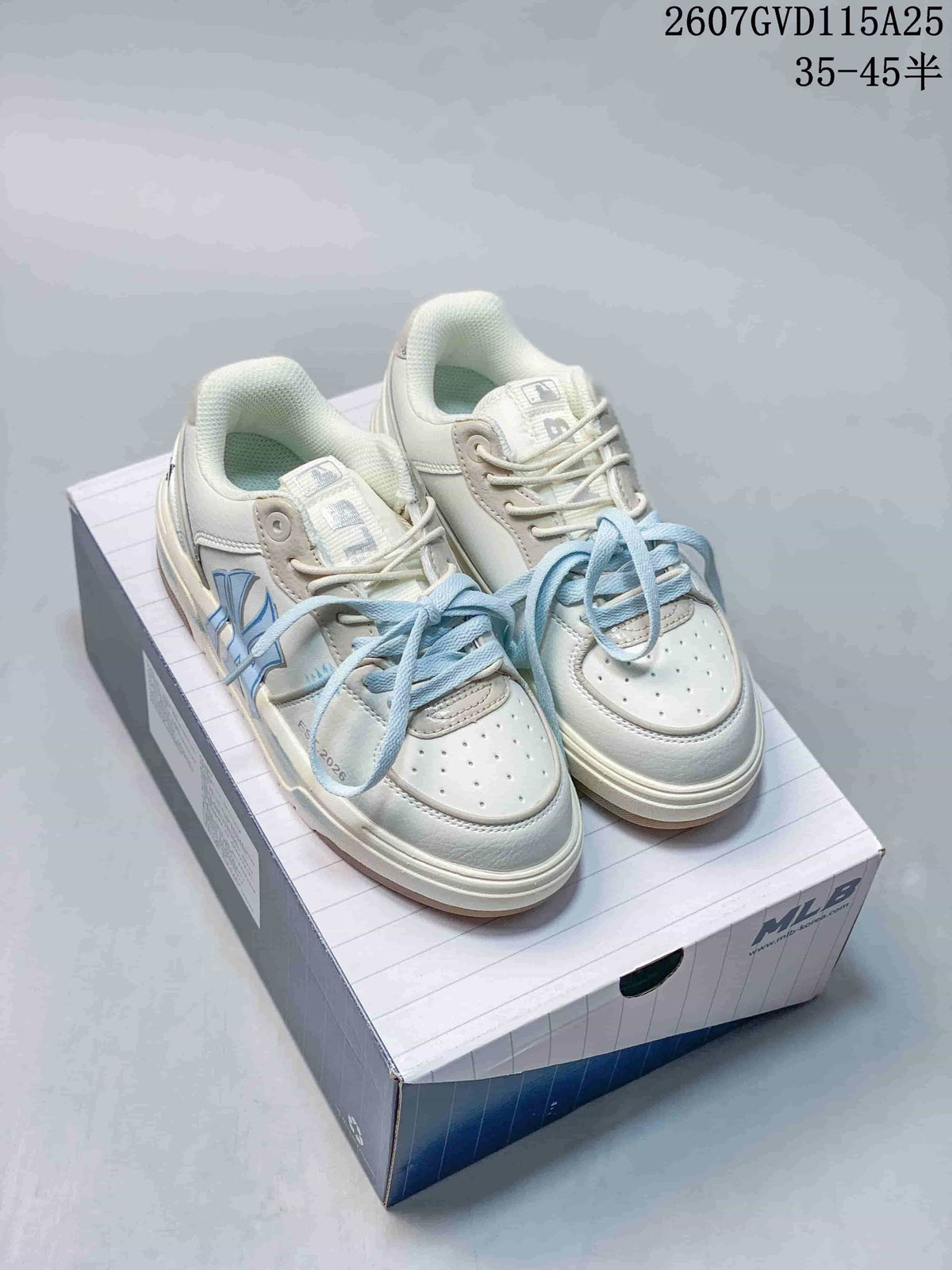 Pair of off-white and light blue MLB low-top sneakers displayed on a branded shoebox.