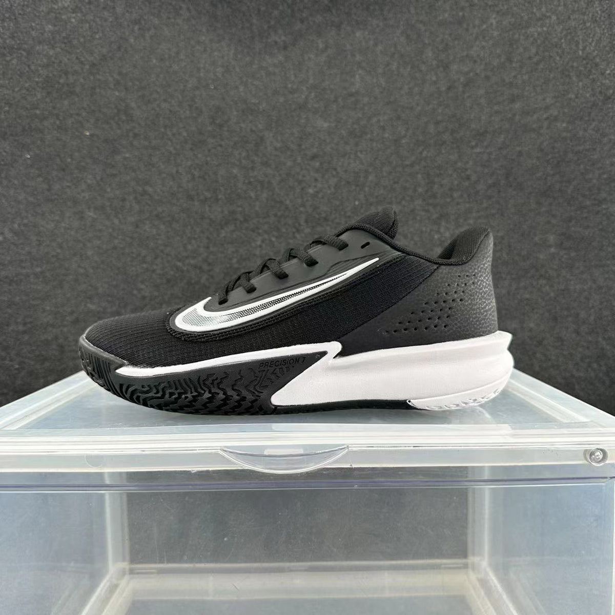 Black and white Nike Precision 7 basketball shoe shown from the side
