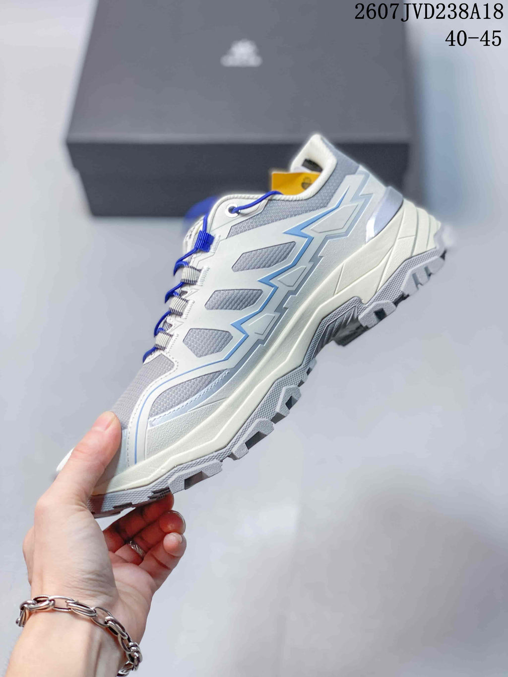 Side view of a white and blue KAILAS hiking shoe showing mesh panels, supportive overlays, and a rugged sole.