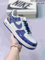 Close-up of a white low-top sneaker with dark blue patterned panels, blue Swoosh, blue laces, and a blue outsole; image text shows style code 2607JDD1359A19 and size range 36-45.