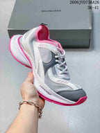Gray and white mesh sneaker with pink accents and a chunky sole