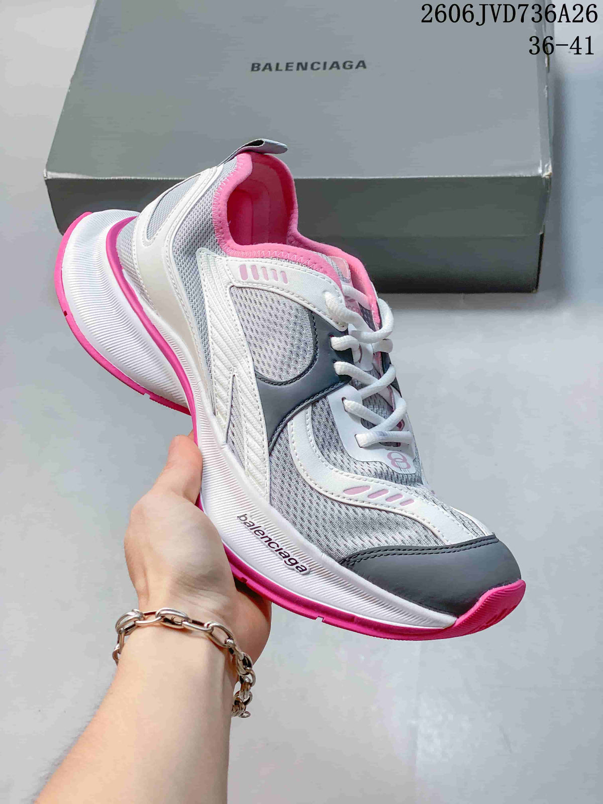 Gray and white mesh sneaker with pink accents and a chunky sole