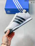 Side profile of the white and black low-top sneaker showing the three side stripes, lace-up design, and layered sole.
