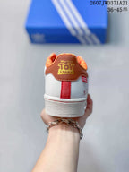 Rear view showing the brown heel panel, orange patterned collar lining, and red heel detail.