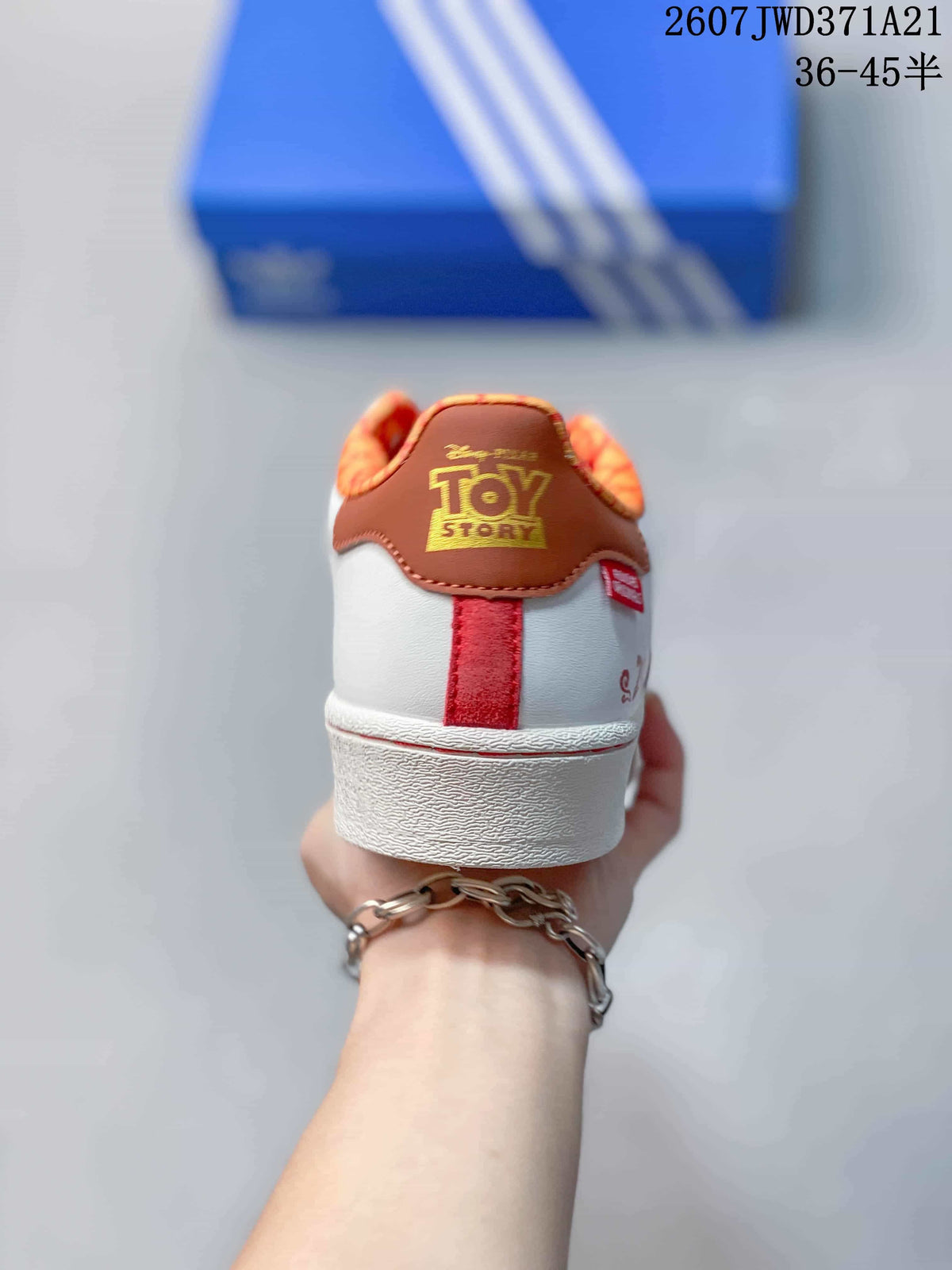Rear view showing the brown heel panel, orange patterned collar lining, and red heel detail.