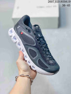 Dark gray On sneaker with a contrasting white segmented outsole and visible side branding.