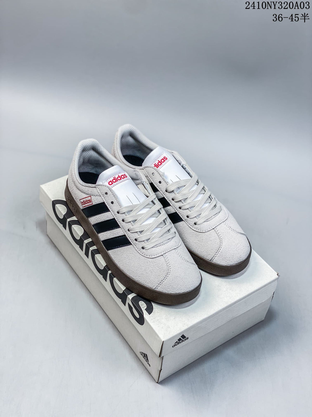 White and black Adidas Neo VL Court 2.0 sneakers displayed on an Adidas shoebox.