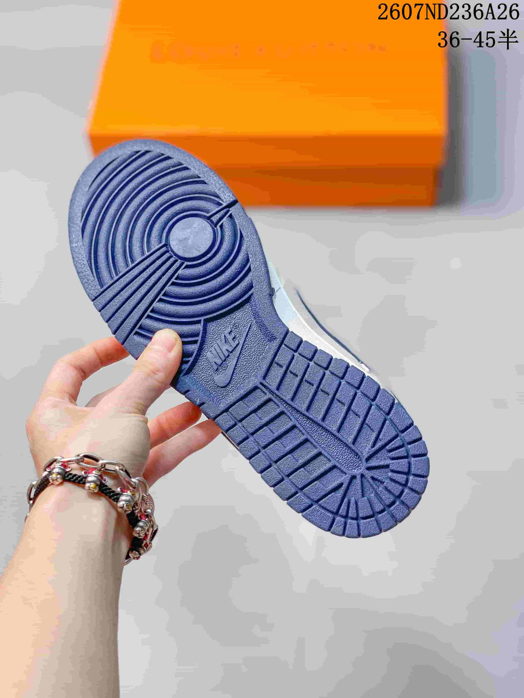 Close-up of the blue rubber outsole showing circular and segmented traction grooves.