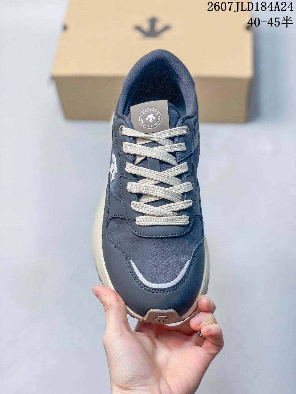 Top view of a navy lace-up sneaker with cream laces, padded collar and contrasting toe trim.