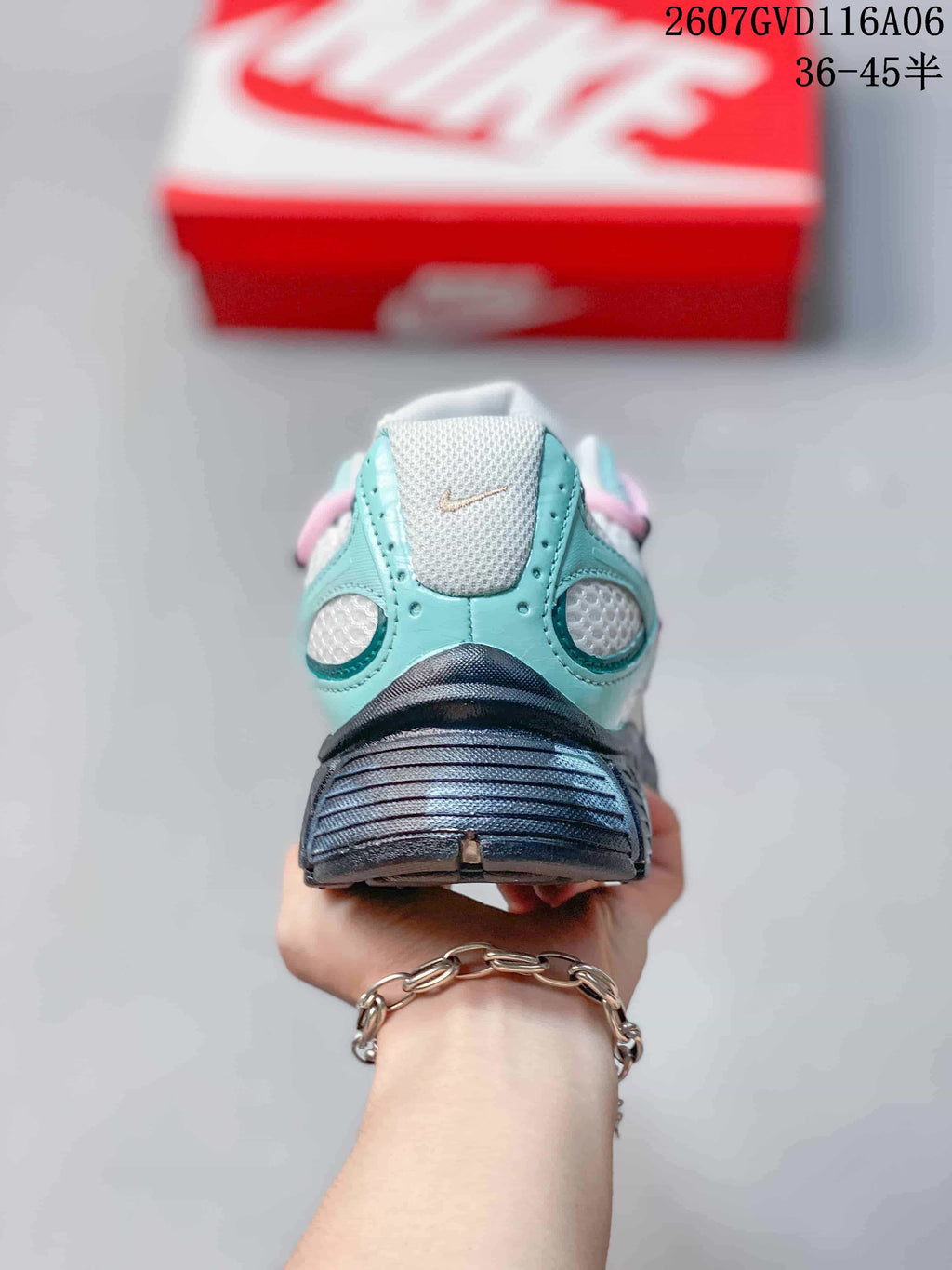 Rear view of the mint and white Nike V5 RNR sneaker showing the padded collar, heel structure and dark outsole.