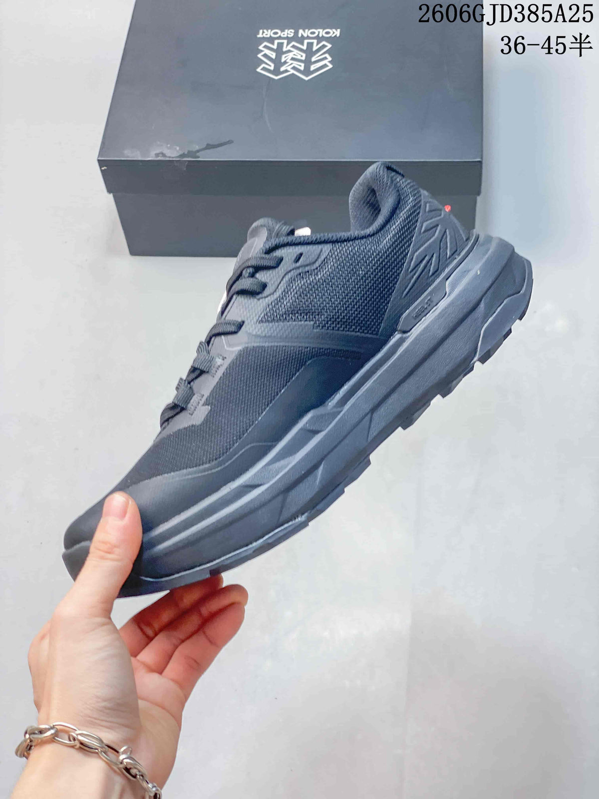 Side view of the charcoal Kolon Sport low-top shoe with mesh-style panels and a rugged sole.