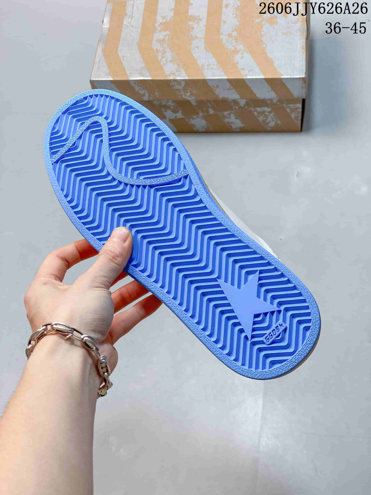 Blue outsole shown from below with a zigzag tread pattern and star-shaped detail.