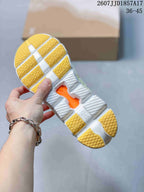 Close-up of the white and yellow segmented outsole showing CloudTec and Speedboard markings.
